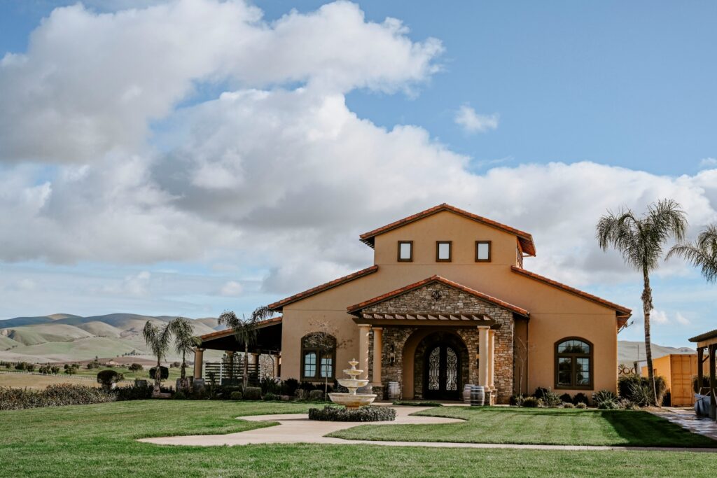 McGrail Vineyards tasting room exterior with lawn, palm trees, and Livermore Valley views.