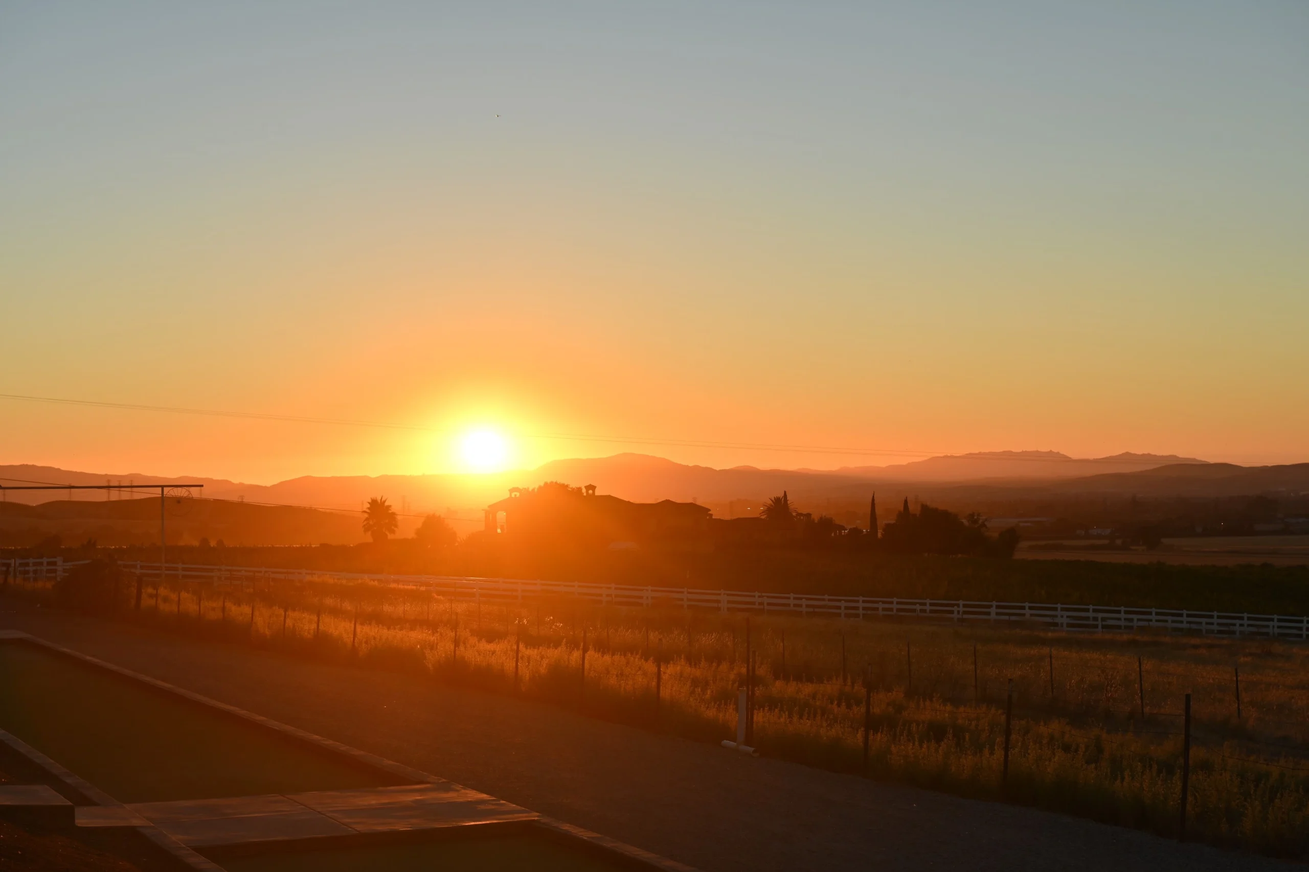Golden Bay Area sunset over vineyard hills near McGrail Vineyards.
