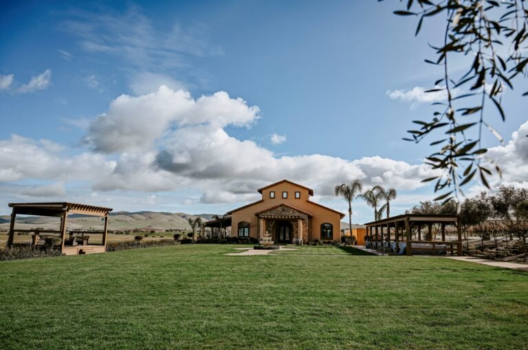 McGrail Vineyards surrounded by rolling hills, lush lawn, and open skies.