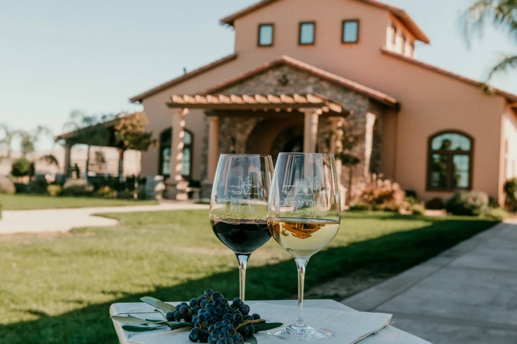 Two McGrail wine glasses with grapes outside the Livermore Valley tasting room.
