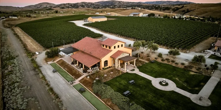 Aerial view of McGrail Vineyards tasting room, estate vines, lawns, and Livermore Valley hills.